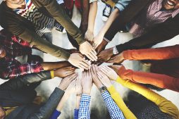 group of people with their hands in centre