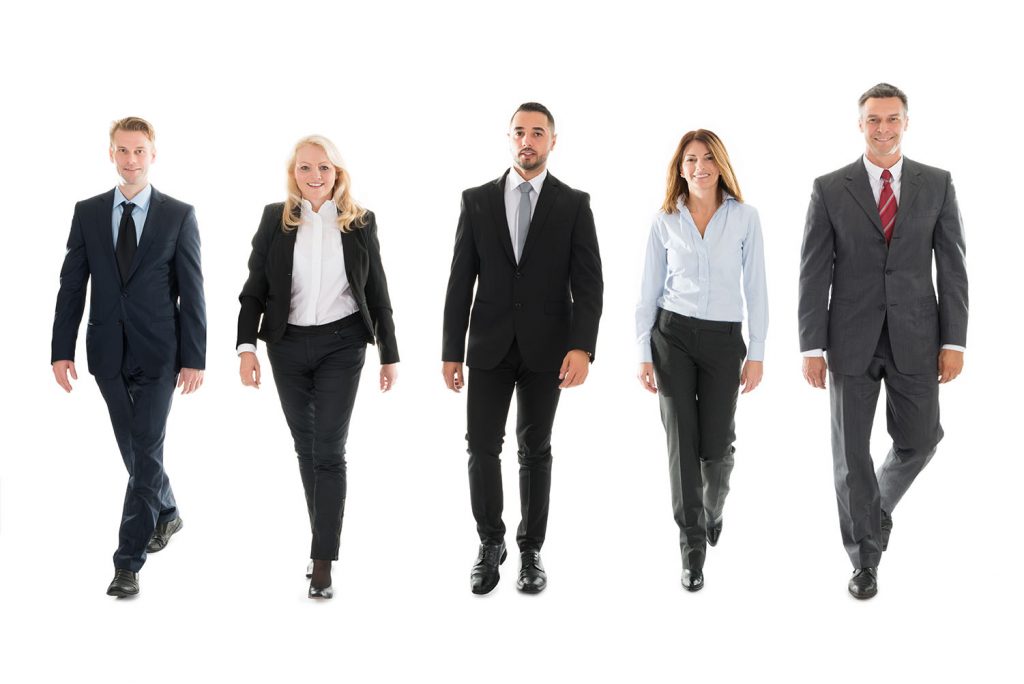 group of people in suits walking forward